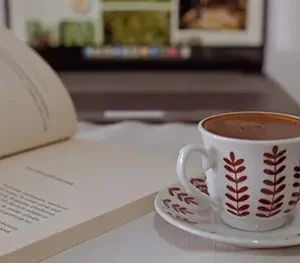 coffee mug next to book